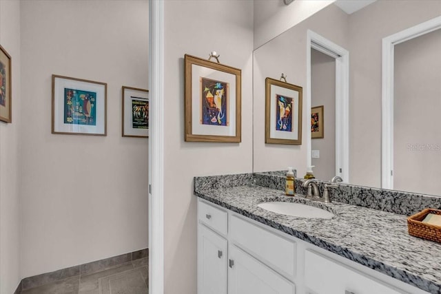 bathroom featuring vanity, baseboards, and tile patterned flooring