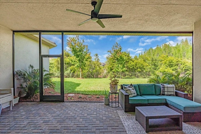 sunroom / solarium featuring a ceiling fan and an outdoor hangout area