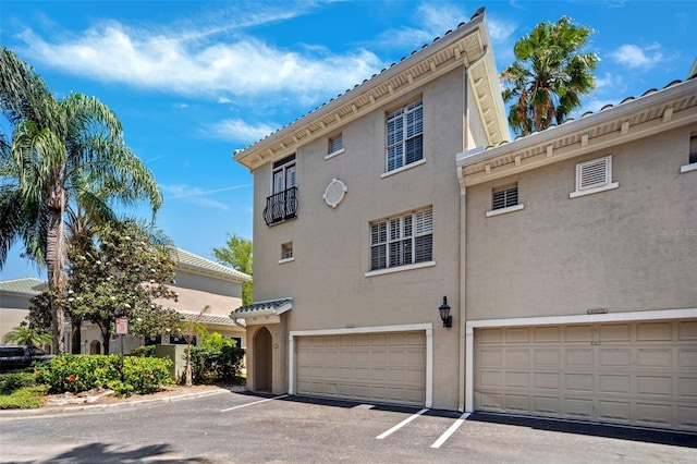 view of home's exterior with stucco siding and an attached garage