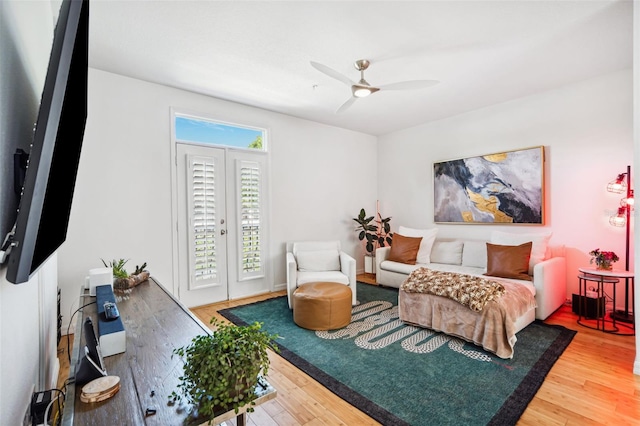 bedroom with french doors, access to exterior, ceiling fan, and wood finished floors