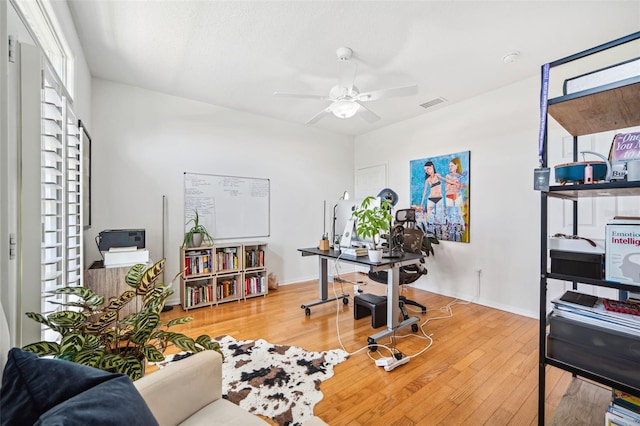 office with wood-type flooring, visible vents, baseboards, and ceiling fan