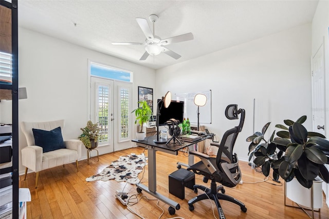 office space featuring light wood-style flooring, french doors, and ceiling fan