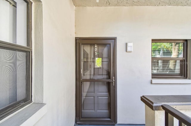 entrance to property with stucco siding