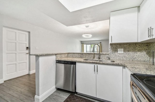 kitchen with a sink, white cabinetry, baseboards, and stainless steel appliances
