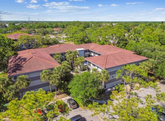 birds eye view of property with a forest view