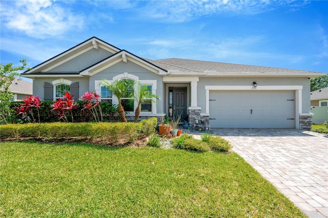 2511 Early Dawn Ct, Valrico, FL 33594 - view of front of house with an attached garage, a front yard, decorative driveway, and stucco siding