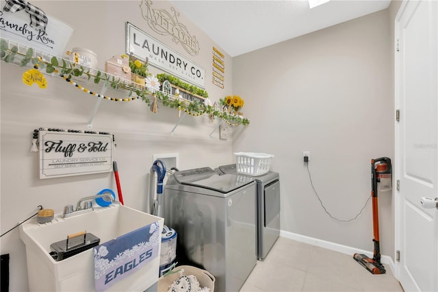 2511 Early Dawn Ct, Valrico, FL 33594 - laundry room with tile patterned floors, laundry area, a sink, washing machine and dryer, and baseboards