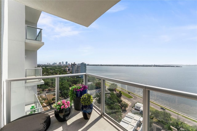 balcony with a water view and a city view