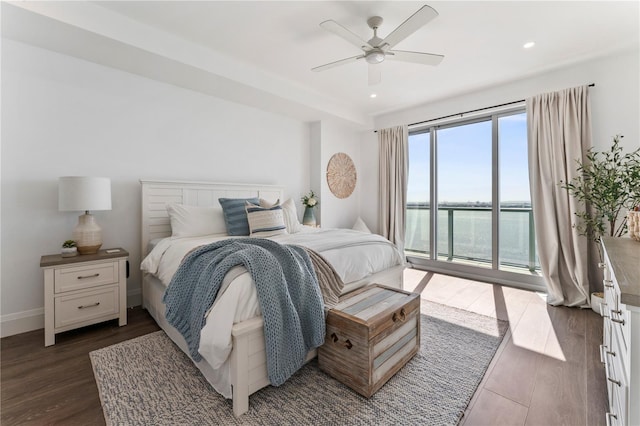 bedroom featuring access to outside, a ceiling fan, recessed lighting, a water view, and dark wood-style floors