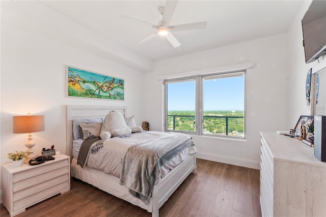 bedroom featuring baseboards, a ceiling fan, and dark wood finished floors