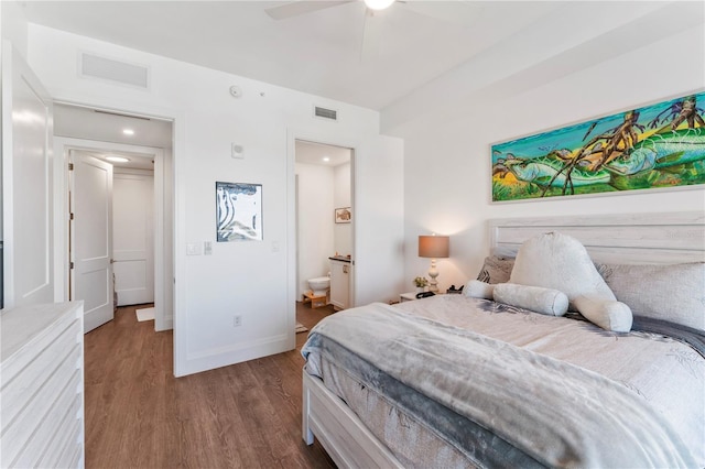 bedroom with visible vents, baseboards, connected bathroom, and dark wood finished floors