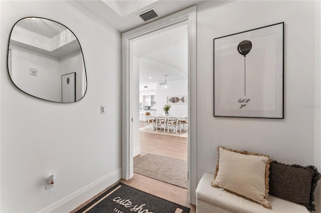interior space featuring wood finished floors, baseboards, and visible vents
