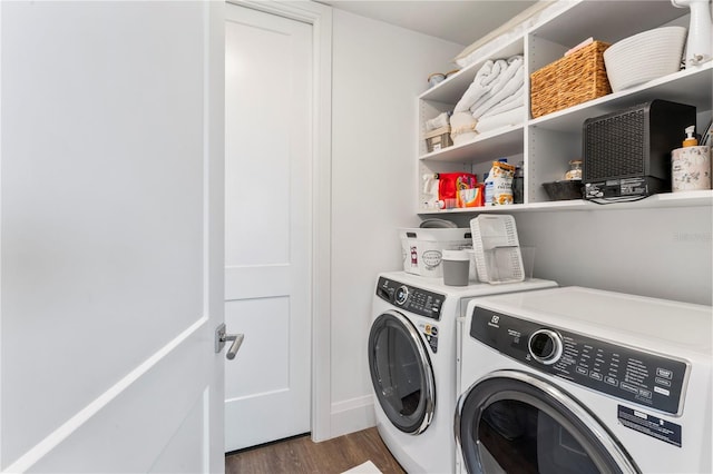 laundry area with wood finished floors, separate washer and dryer, and laundry area