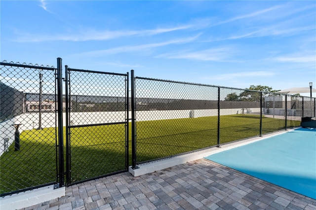 exterior space with a lawn, fence, and a gate