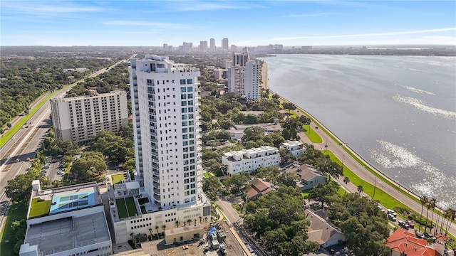 birds eye view of property with a water view and a view of city