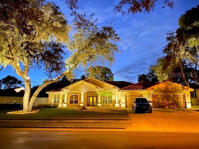 8933 Crescent Forest Blvd, New Port Richey, FL 34654 - view of front facade featuring a garage, concrete driveway, and a front lawn