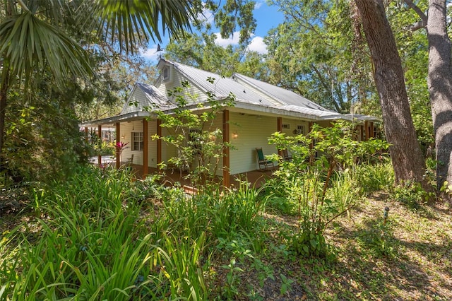 view of side of property featuring metal roof