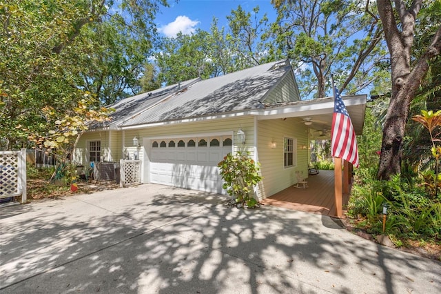 187 Sage Cir, Crystal Beach, FL 34681 - view of home's exterior with ceiling fan, concrete driveway, an attached garage, and a carport