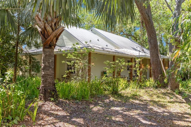 187 Sage Cir, Crystal Beach, FL 34681 - view of property exterior with metal roof