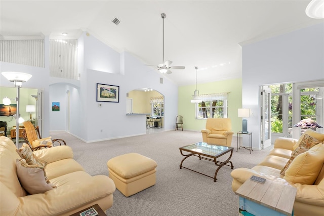 187 Sage Cir, Crystal Beach, FL 34681 - living room featuring arched walkways, a ceiling fan, high vaulted ceiling, carpet floors, and baseboards