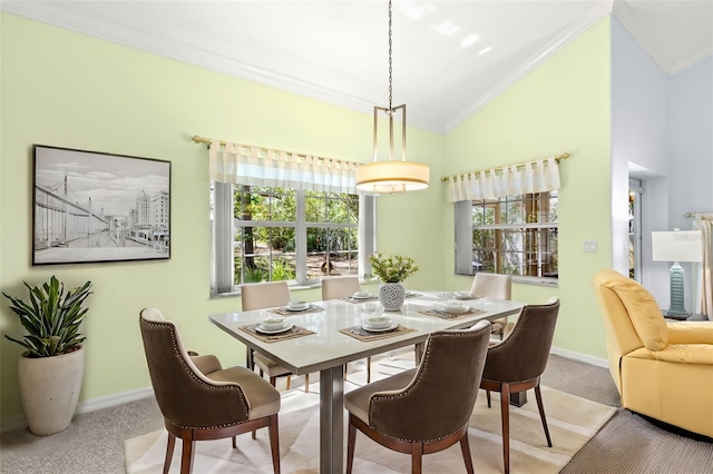 187 Sage Cir, Crystal Beach, FL 34681 - carpeted dining area featuring crown molding, lofted ceiling, and baseboards