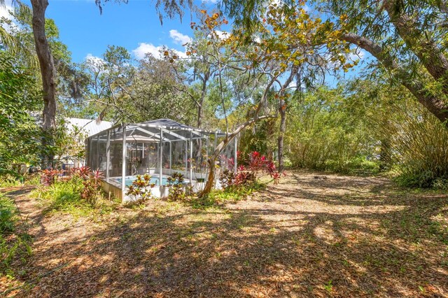 187 Sage Cir, Crystal Beach, FL 34681 - view of yard featuring a lanai and an outdoor pool