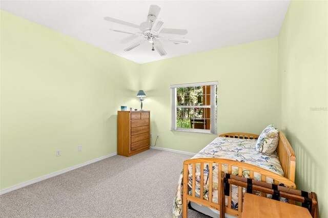 187 Sage Cir, Crystal Beach, FL 34681 - carpeted bedroom with baseboards and a ceiling fan