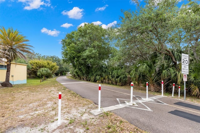 187 Sage Cir, Crystal Beach, FL 34681 - view of asphalt road with traffic signs
