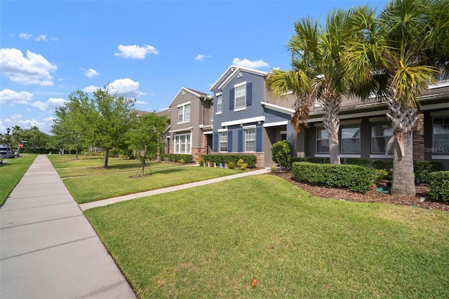 view of front of house with a front yard and stucco siding