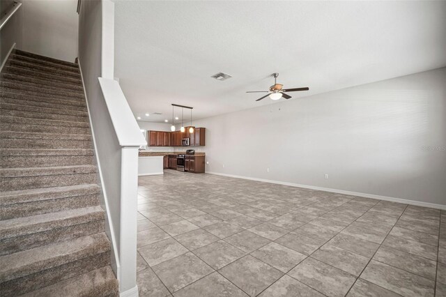 staircase with a ceiling fan, visible vents, recessed lighting, tile patterned floors, and baseboards
