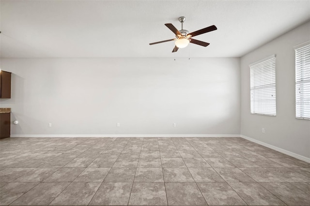 unfurnished living room featuring light tile patterned floors, baseboards, and ceiling fan