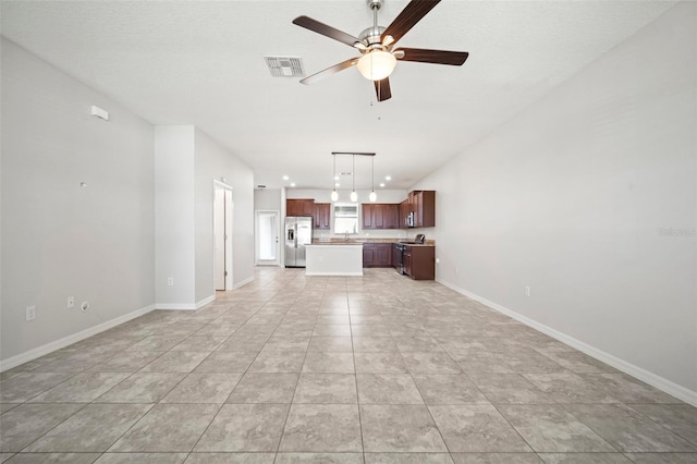 unfurnished living room featuring visible vents, baseboards, and ceiling fan