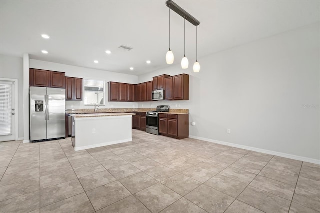kitchen with light countertops, light tile patterned flooring, visible vents, appliances with stainless steel finishes, and pendant lighting