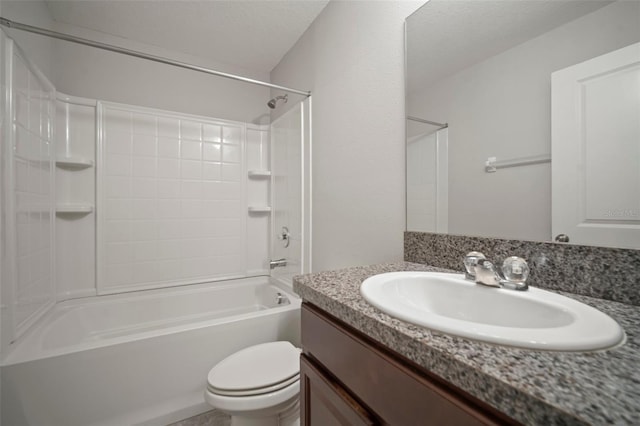 bathroom featuring vanity, shower / bathing tub combination, and toilet