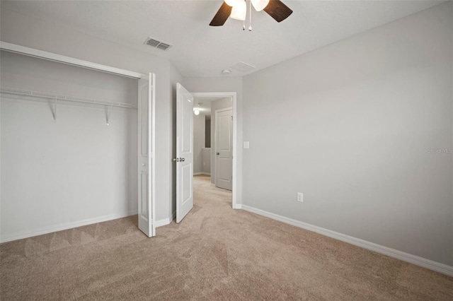 unfurnished bedroom with a closet, light colored carpet, baseboards, and visible vents