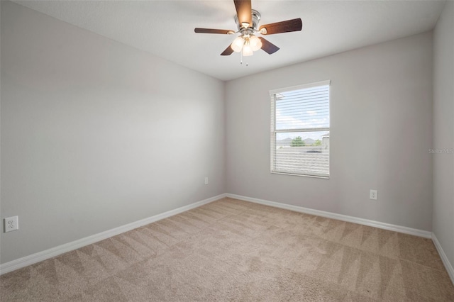 empty room featuring baseboards, carpet flooring, and ceiling fan