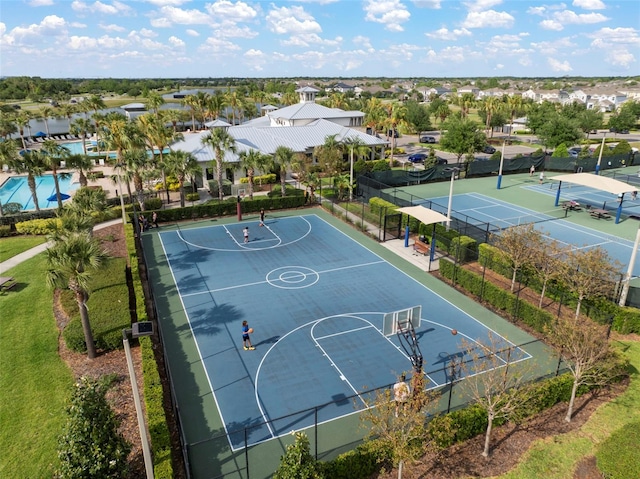 view of basketball court with community basketball court and fence