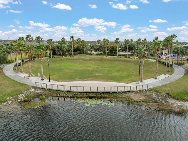 view of property's community with a water view and a yard