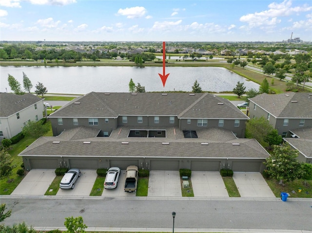 drone / aerial view featuring a water view and a residential view