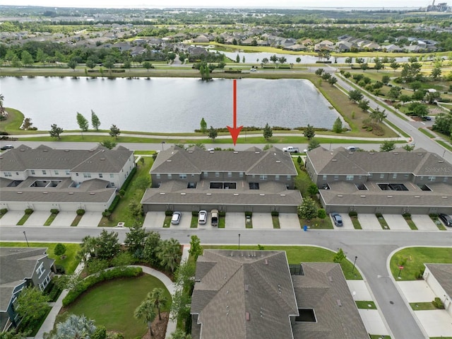 drone / aerial view with a residential view and a water view