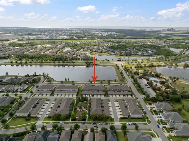 drone / aerial view with a residential view and a water view
