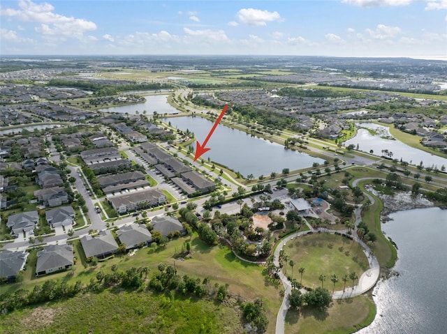 drone / aerial view with a water view and a residential view
