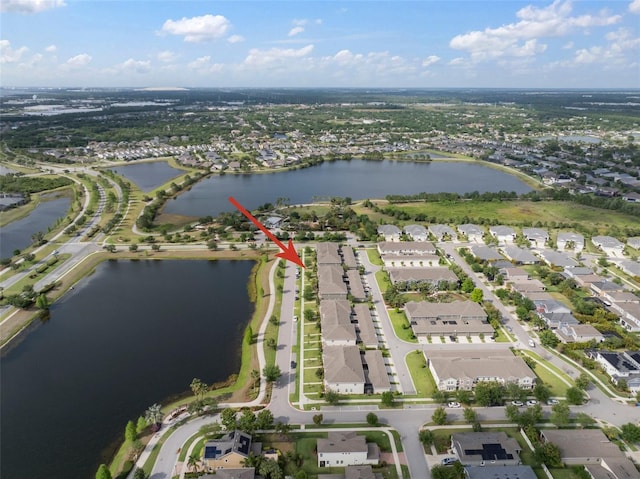 drone / aerial view with a residential view and a water view