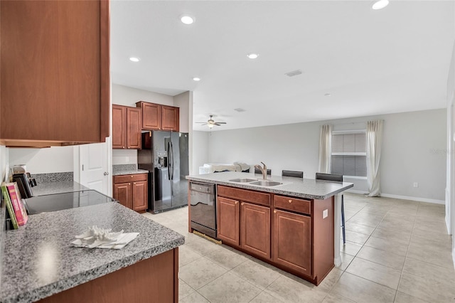kitchen featuring light tile patterned floors, a sink, black appliances, and a ceiling fan