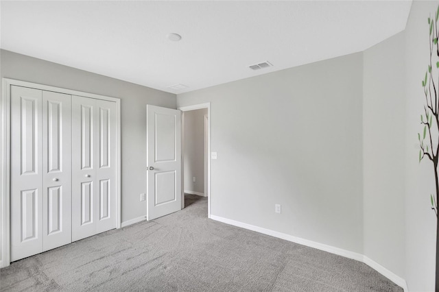 unfurnished bedroom featuring visible vents, baseboards, a closet, and carpet