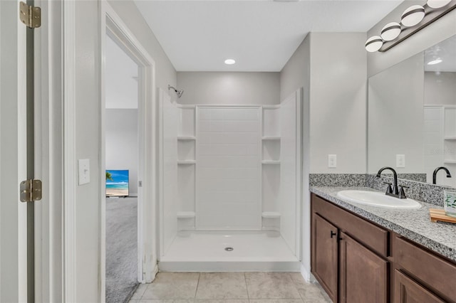 bathroom featuring a shower stall, tile patterned flooring, and vanity