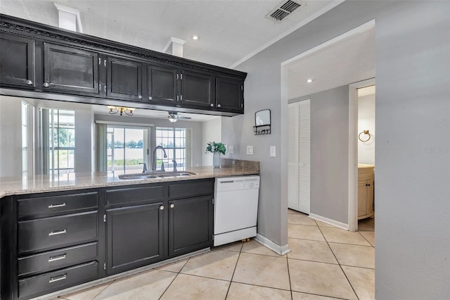 8719 Lake Place Ln, Tampa, FL 33634 - kitchen featuring dark cabinets, visible vents, light tile patterned floors, white dishwasher, and a sink