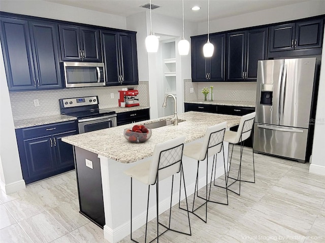 5509 Cumberland Star Ct, Lutz, FL 33558 - kitchen featuring appliances with stainless steel finishes, a sink, a breakfast bar, backsplash, and a kitchen island with sink