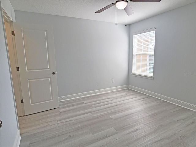 5509 Cumberland Star Ct, Lutz, FL 33558 - spare room with light wood-style flooring, a ceiling fan, and baseboards