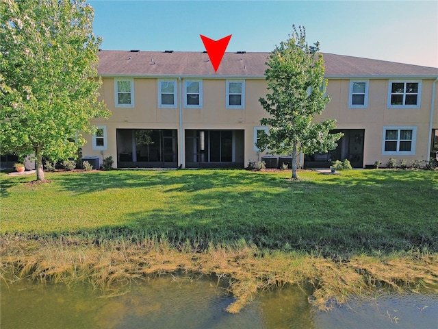 5509 Cumberland Star Ct, Lutz, FL 33558 - rear view of house featuring a lawn, central AC, and stucco siding